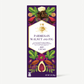 A tall rectangular package of King Cacao Parmesan Walnut and Fig chocolate, featuring a deep purple background with illustrated walnuts, figs, leaves, and a central white label with gold text.