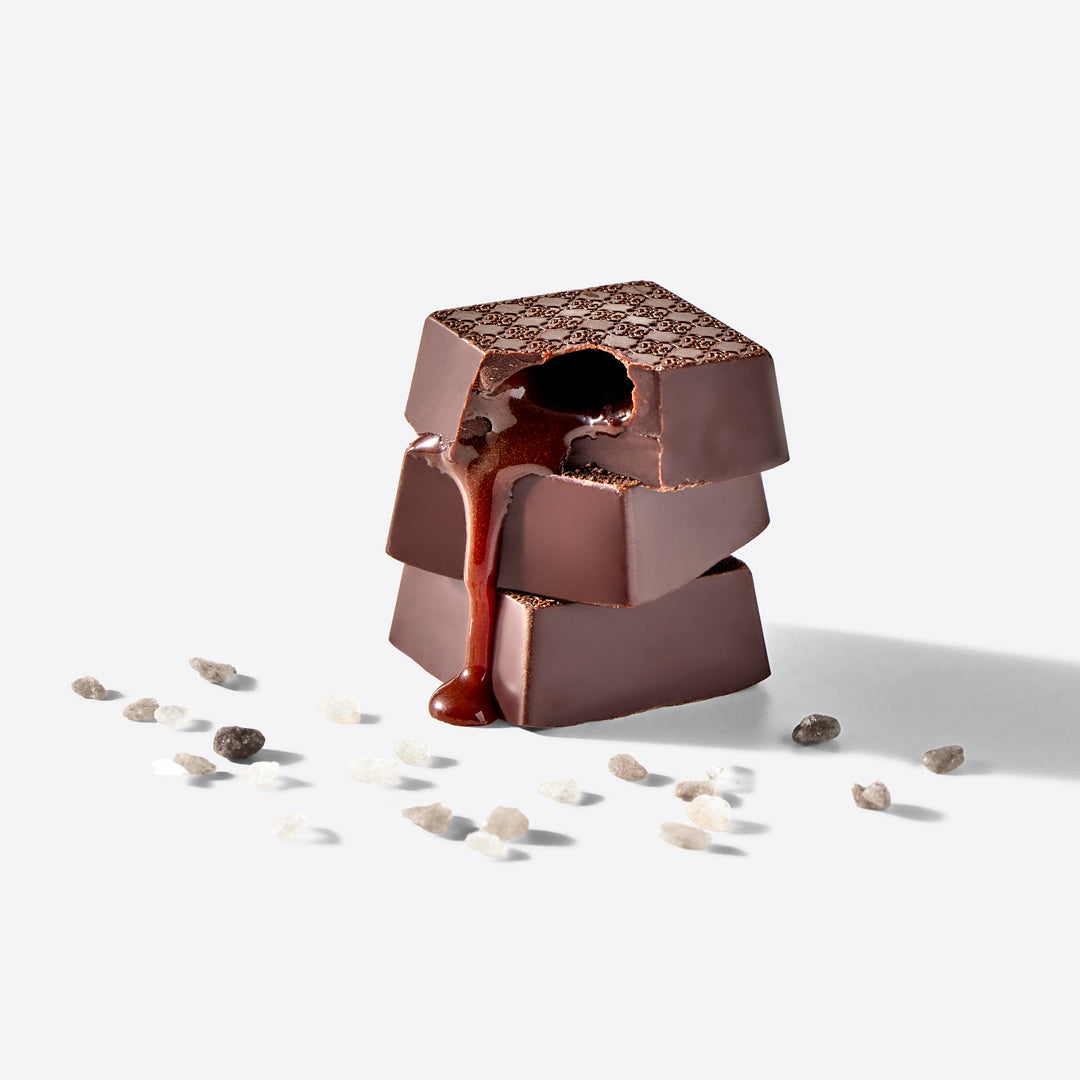 Chocolate sculpture with a flowing chocolate stream on a white background