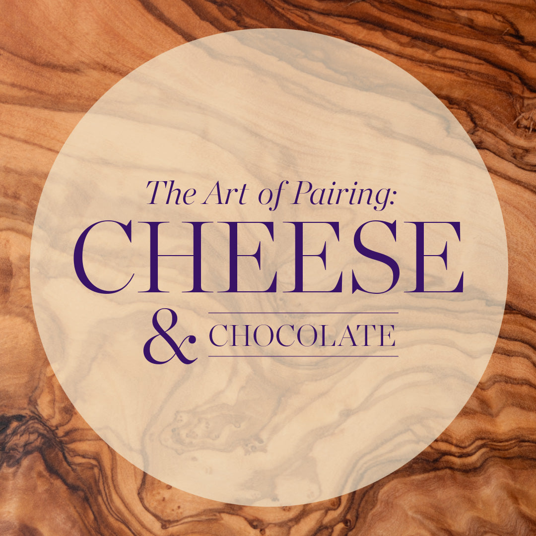 A circular beige marble-style graphic with the text 'The Art of Pairing: CHEESE & CHOCOLATE' in purple, centered over a wood-grain background.