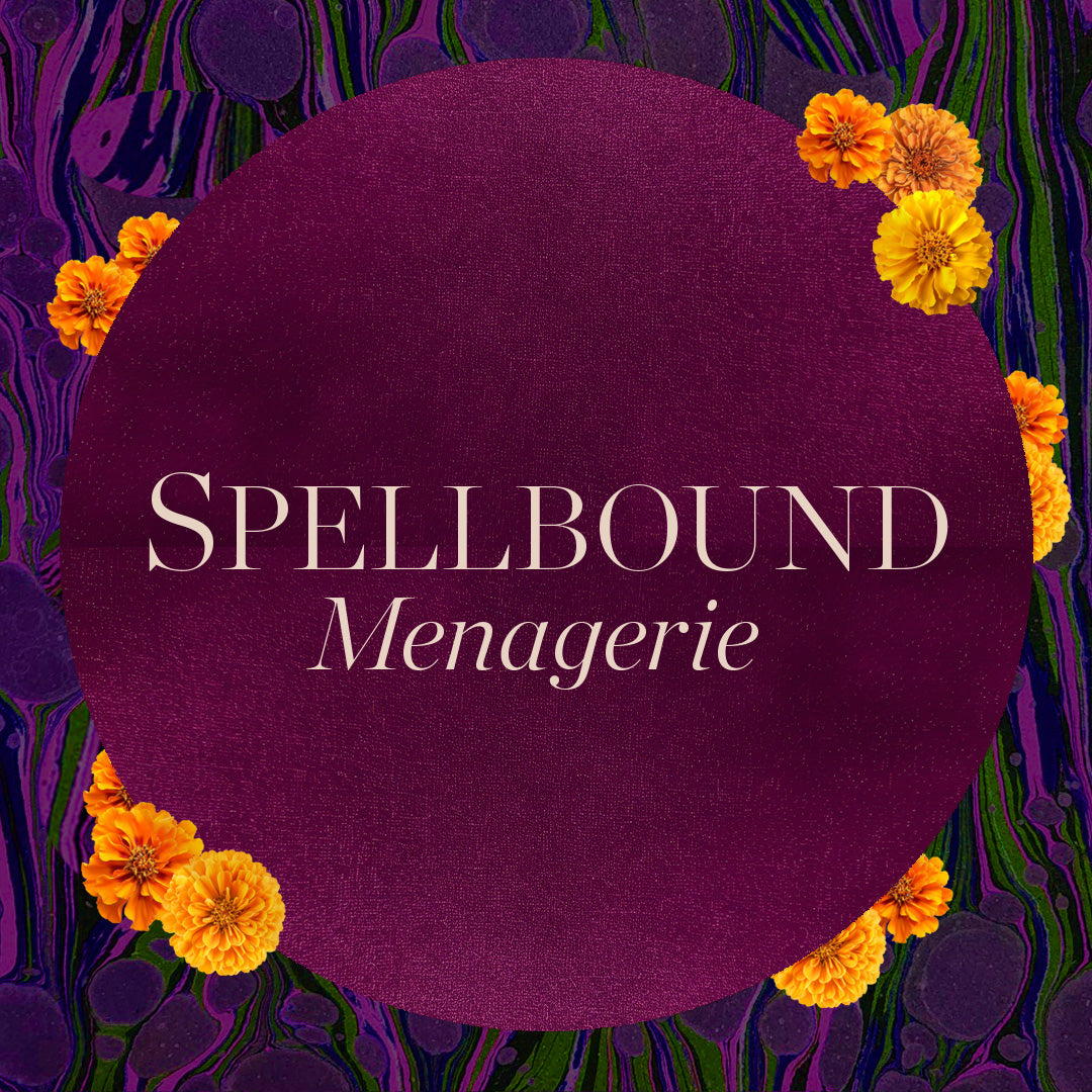 Spellbound Chocolate Menagerie circular burgundy label with orange marigolds on a marbled purple background