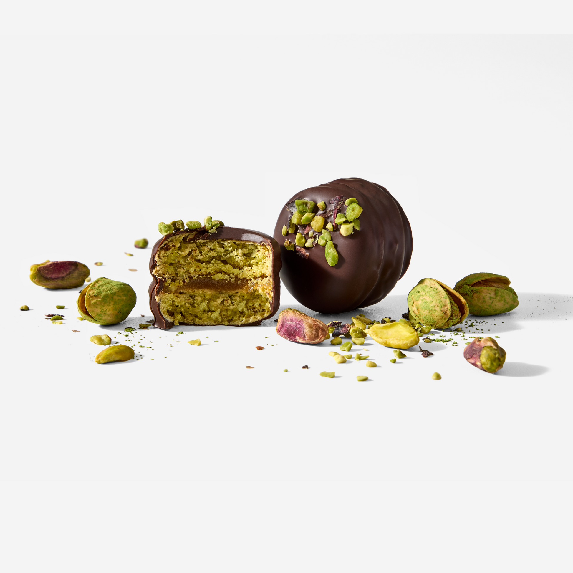 Chocolate-dipped pistachio treats on a white background