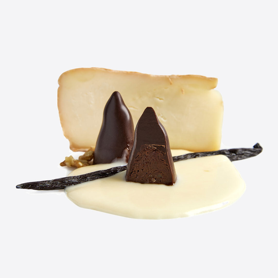 Rooster Truffles conical dark chocolate pieces with a cheese wedge backdrop