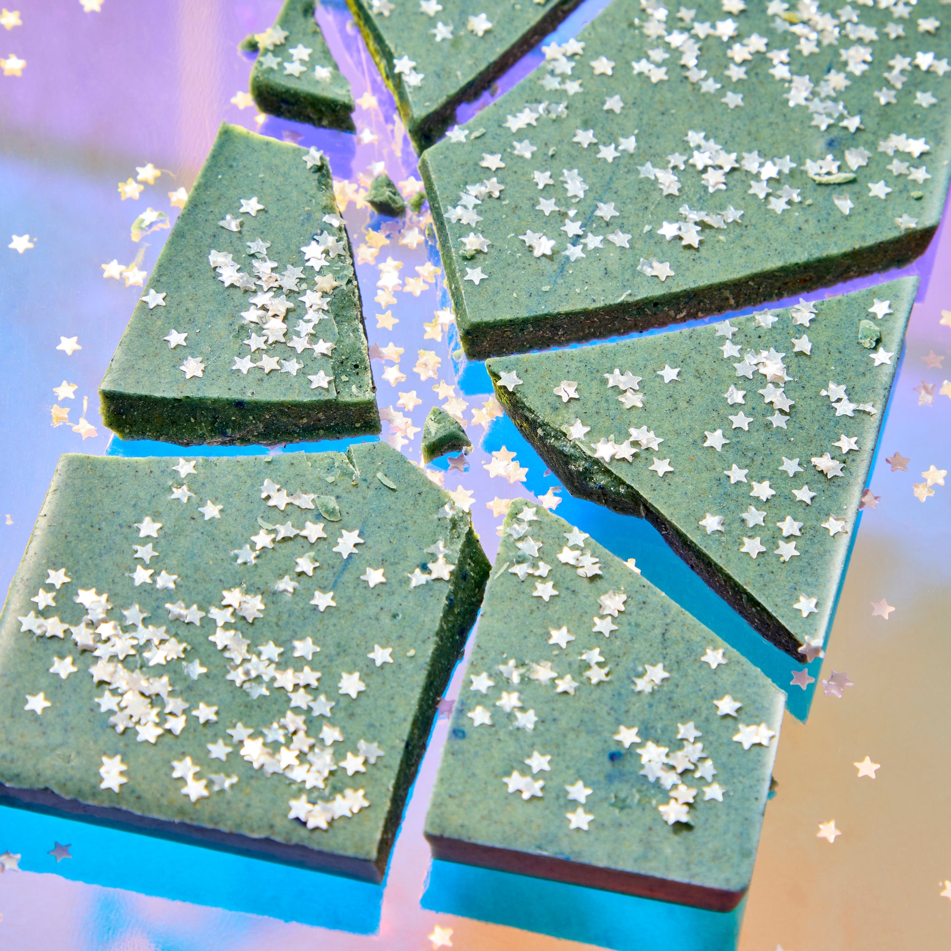 Green soap bars with star-shaped sprinkles on a blue background