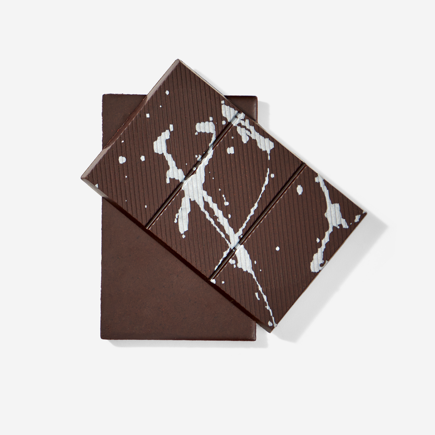 Dark chocolate bar with white marbled pattern on a white background